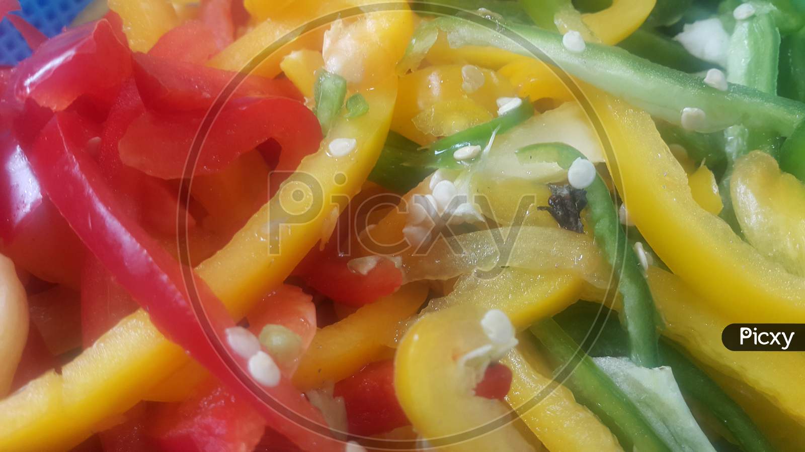Slices Of Colorful Green, Yellow, Red, Purple Hot Shiny Shimla Chilli Or Peppers