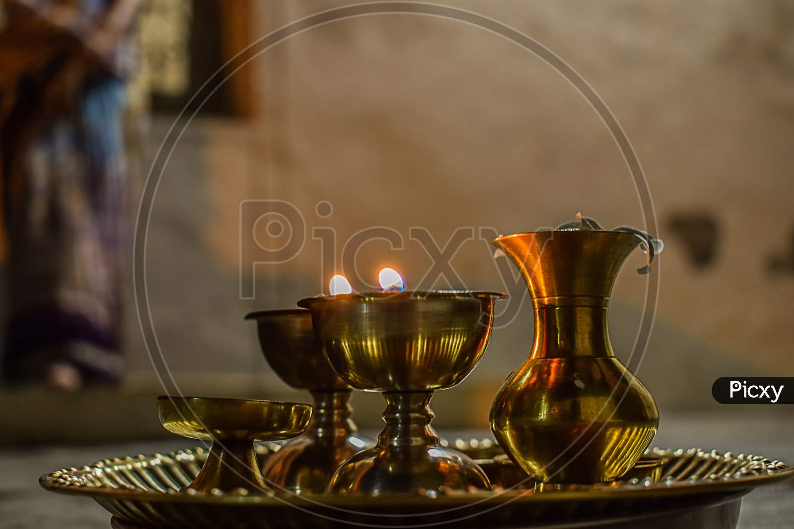 Side View Of Beautiful Copper Oil Lamps And Pooja Thali Decorated For Worshiping God.