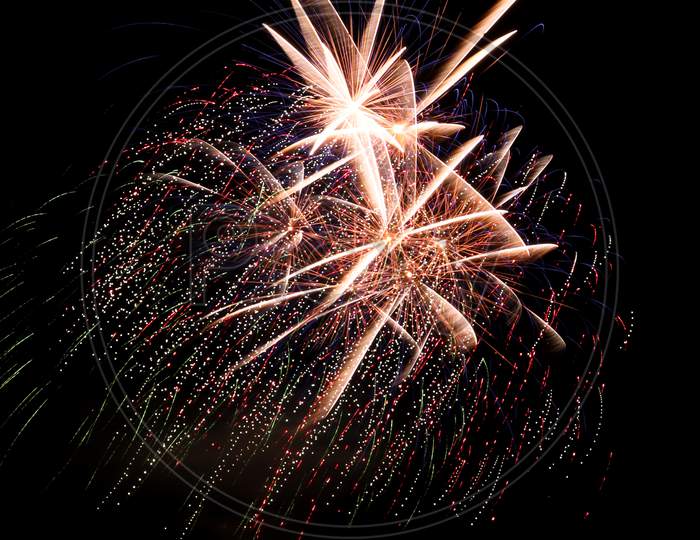 Bright Gold Fireworks With Streaks Of Color In The Background