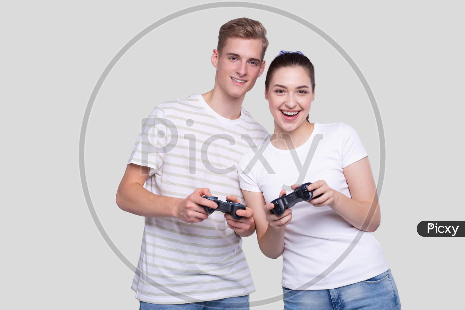 Couple Standing With Joysticks In Hands Smilling Isolated
