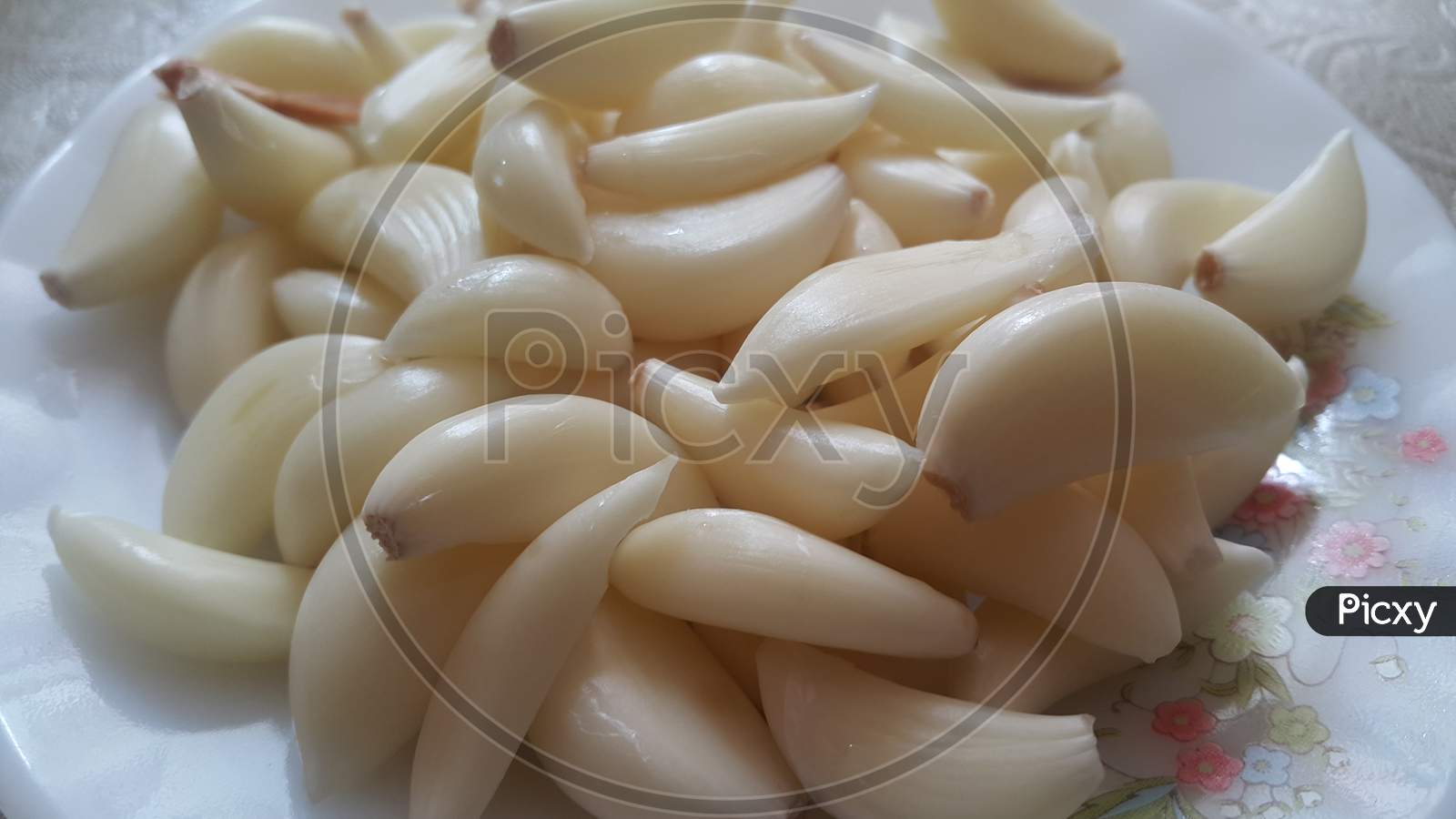 Close-Up View Of Dry Peeled Garlic Clove Background