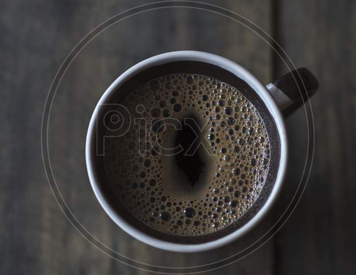 Cup Of Coffee On Wooden Table