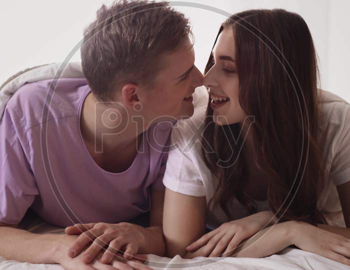 Couple Cuddling In Bed. Couple In Bed Morning