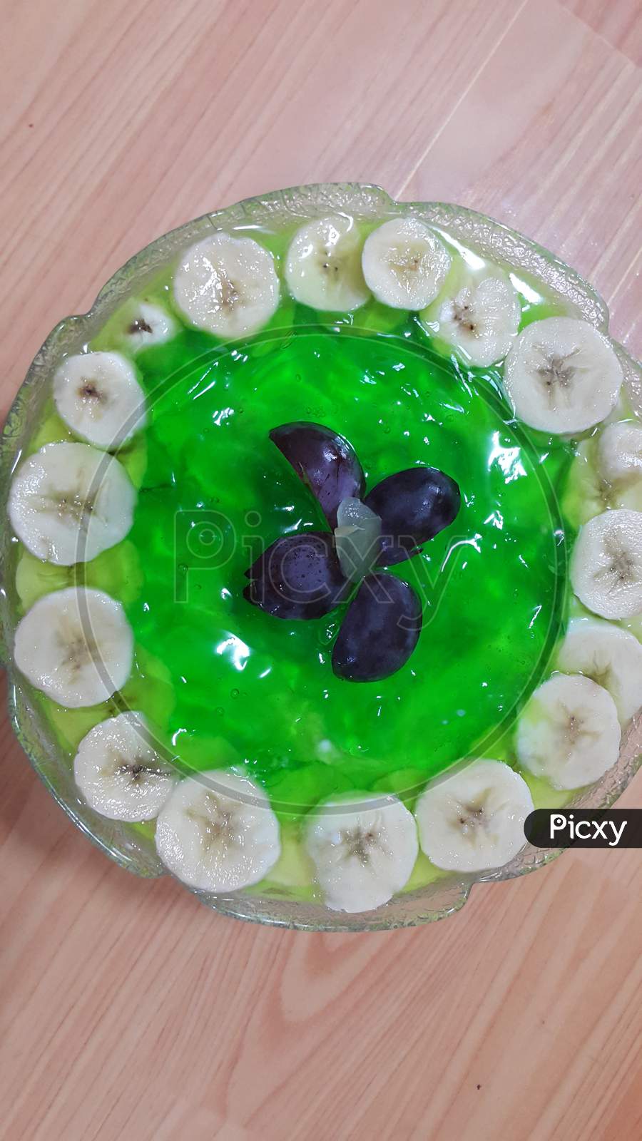 Creamy Tasty Sweet Green Jelly With Banana Slices Layered On Surface
