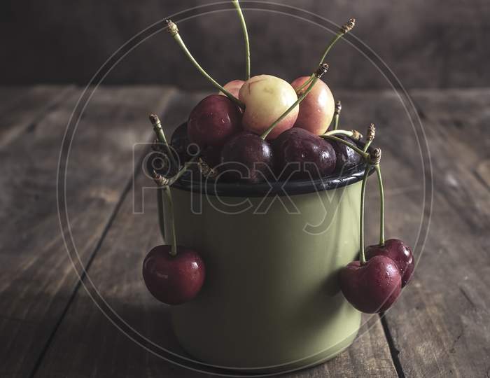 Freshly Picked Cherries On Dark Wooden Table