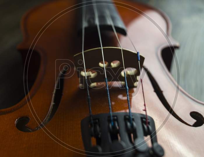 Violin Lying On Wooden Background.