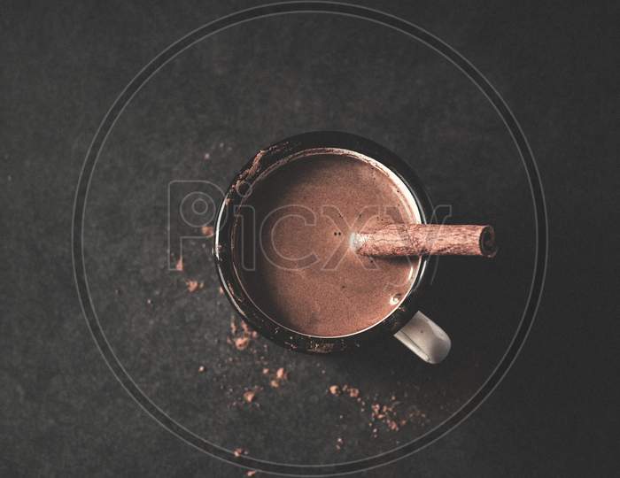 Vintage Mug Of Hot Cocoa With Cinnamon Sticks