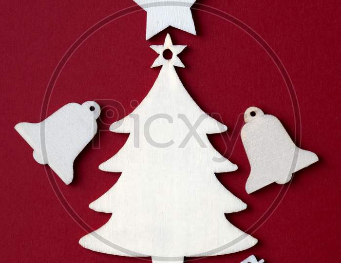 Wooden Christmas Decoration On Red Background.