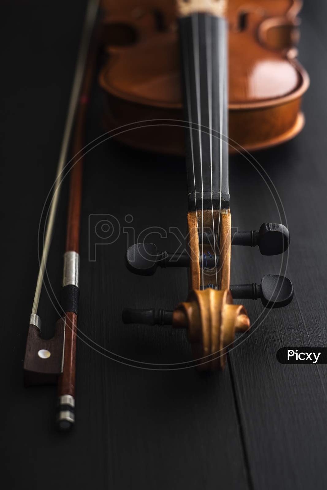 Old Violin With Bow On A Wooden Table