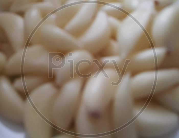 Close-Up View Of Dry Peeled Garlic Clove Background