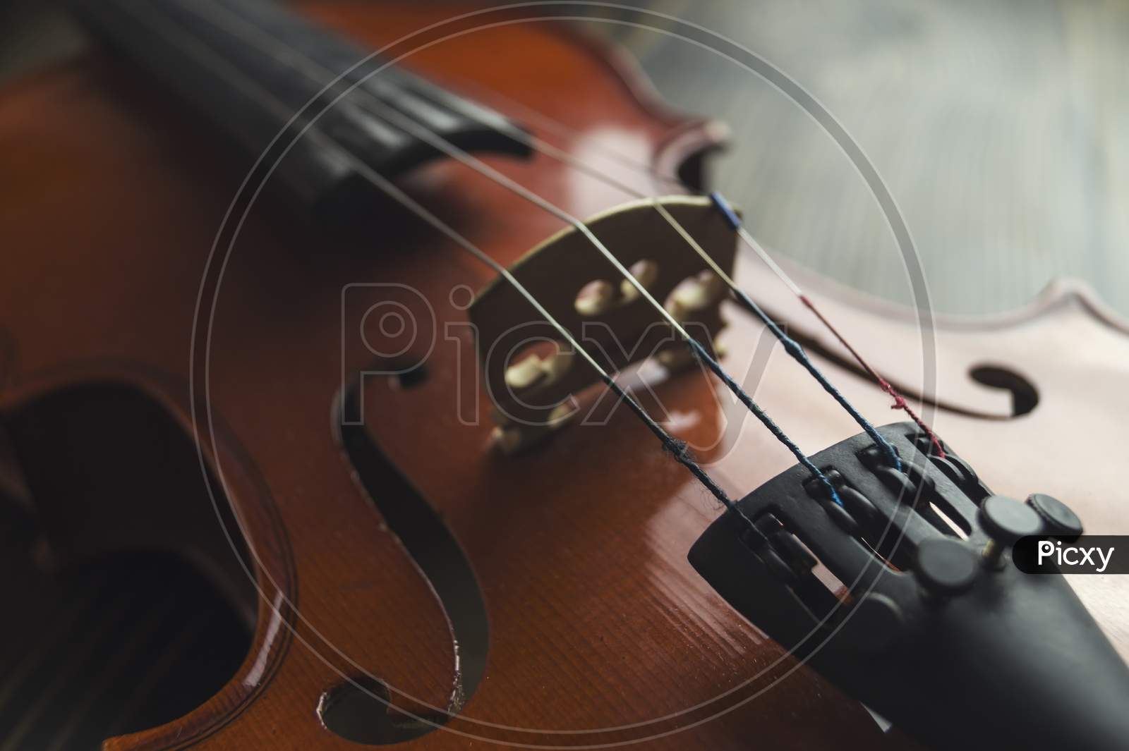 Violin Lying On Wooden Background.