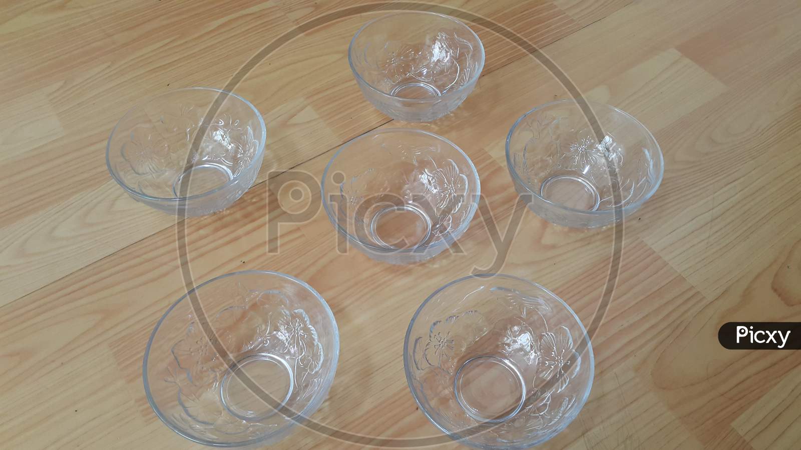Top View Of Empty White Glass Bowls On A Wooden Floor