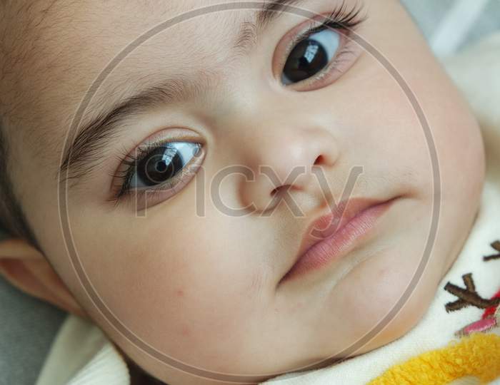 Baby Girl With Lovely Face, Big Eyes And Cute Face Gesture