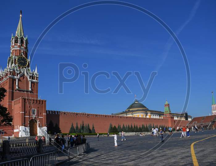 People Walk On Red Square On A Sunny Day