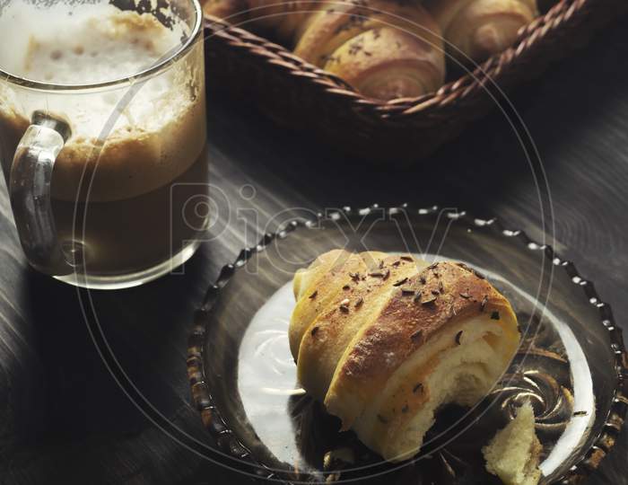 Homemade Buns And Coffee On Wooden Table
