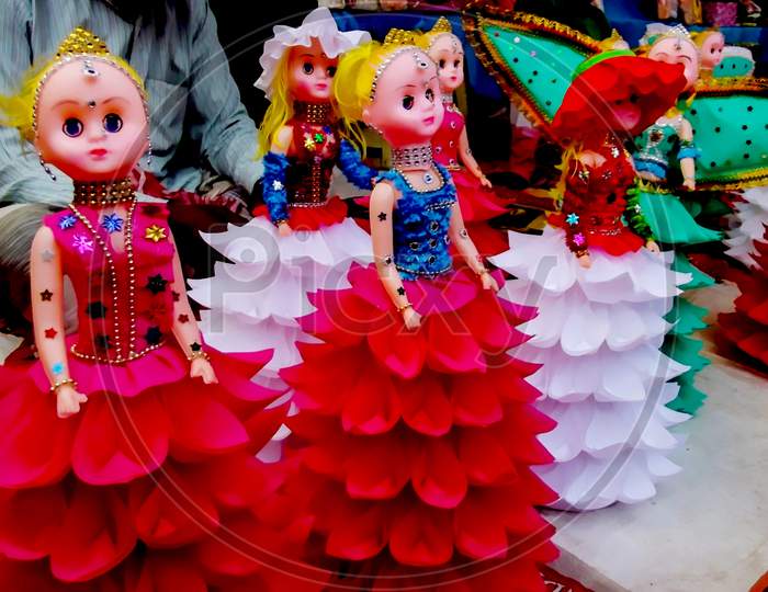 A shop in a village fair selling beaufiful colorful dolls  closeup image