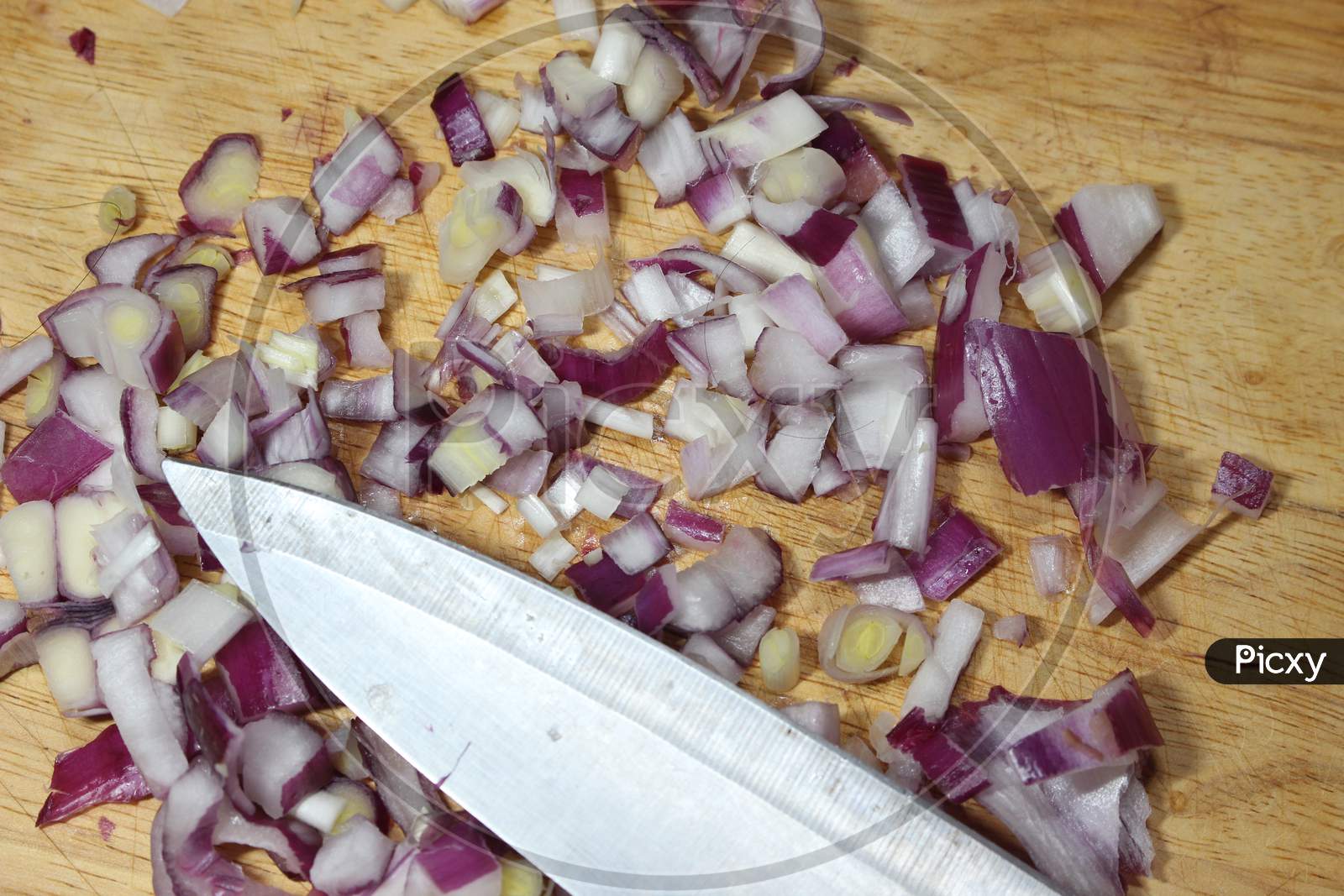 Chopped White Onion With Sharp Knife On Wooden Cutting Board