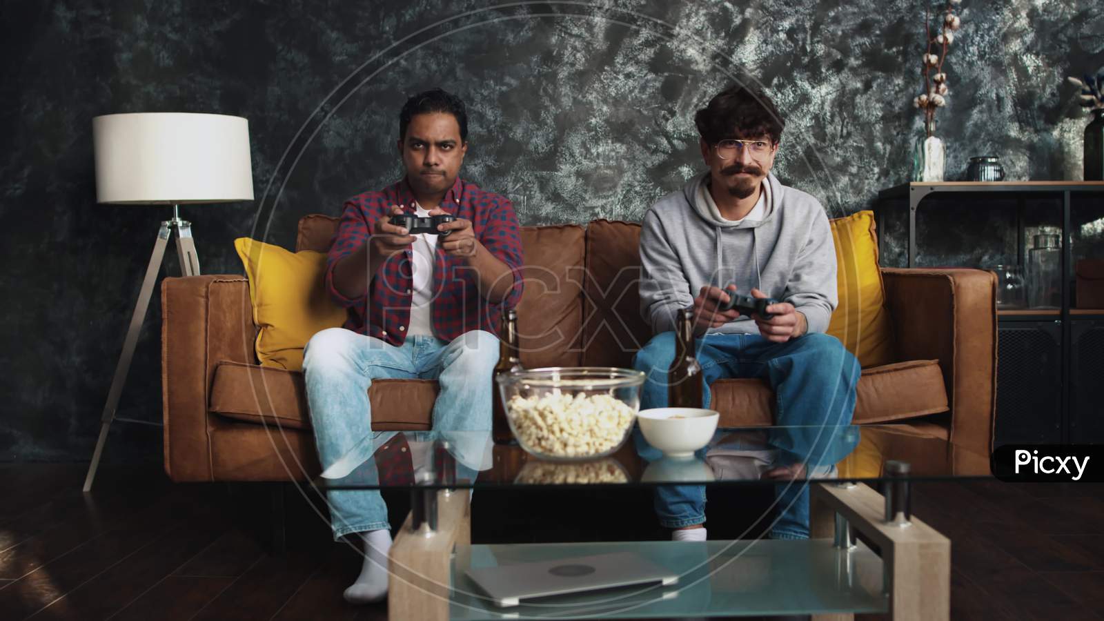 Friends Playing Console Games At Home. Friends At Couch. Gamers At Home. Guys Playing Games. Indian Man Wins The Game