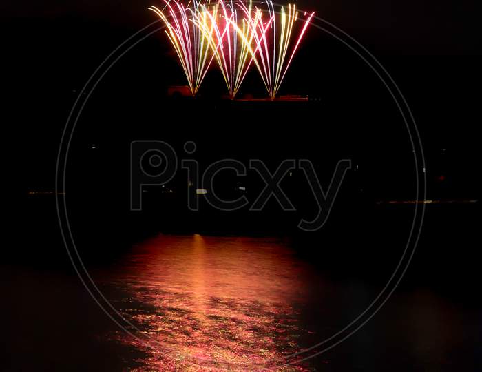 Multi-Colored Fireworks Over The Water