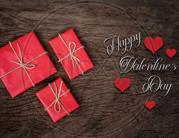 Red Hearts, Rose, Ribbon, Message Card And Gift Box On Wooden Table. Valentines Day Background