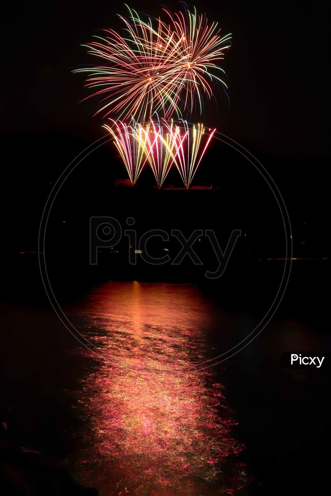 Multi-Colored Fireworks Over The Water