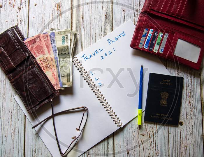 Travel Plans 2021 handwritten along with banknotes