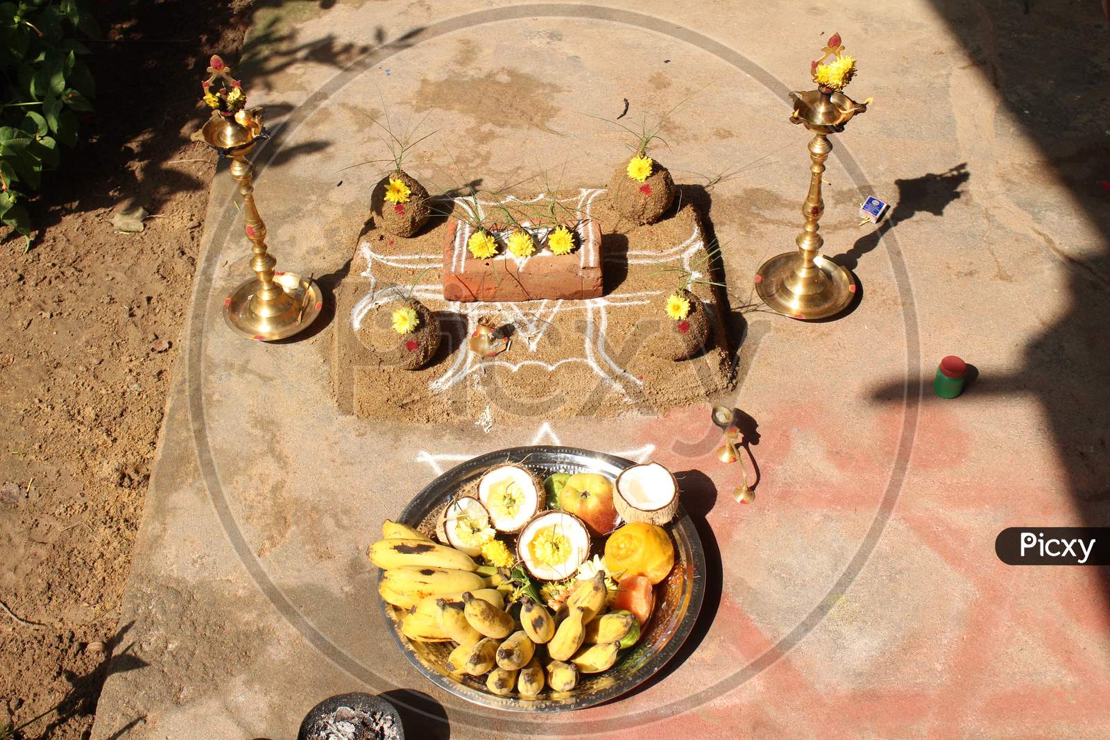 Celebrating Traditional Thai Pongal Festival To Sun God With Pot, Lamp, Wood Fire Stove, Fruits And Sugarcane