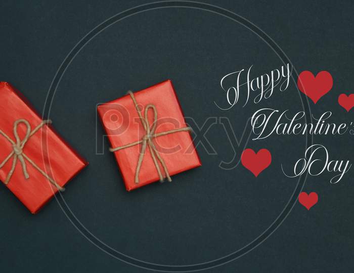 Red Hearts, Rose, Ribbon, Message Card And Gift Box On Wooden Table. Valentines Day Background