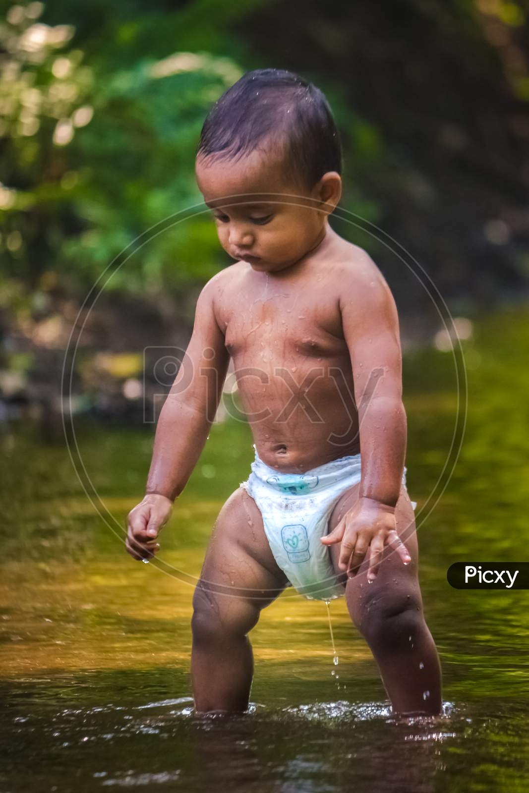 Baby Boy Stock Images - Little Cute Baby Boy Playing In River Water. Portrait of Boy Child Having Fun and Joy On a Forest River. Little Funny Boy Playing In Water.