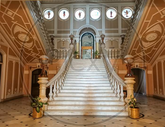 A Bewitching view of the Interiors inside the famous Lalitha Mahal Palace with rich Wooden stairs and colorful painting work at Mysuru,India.