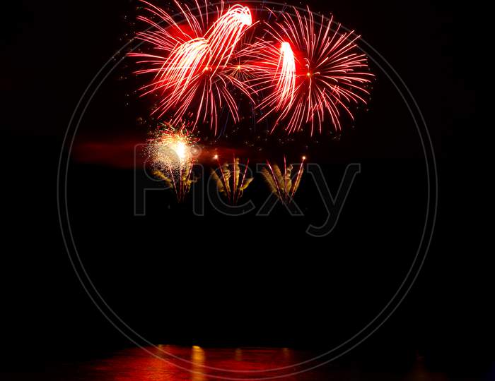 Red Fireworks Over The Water
