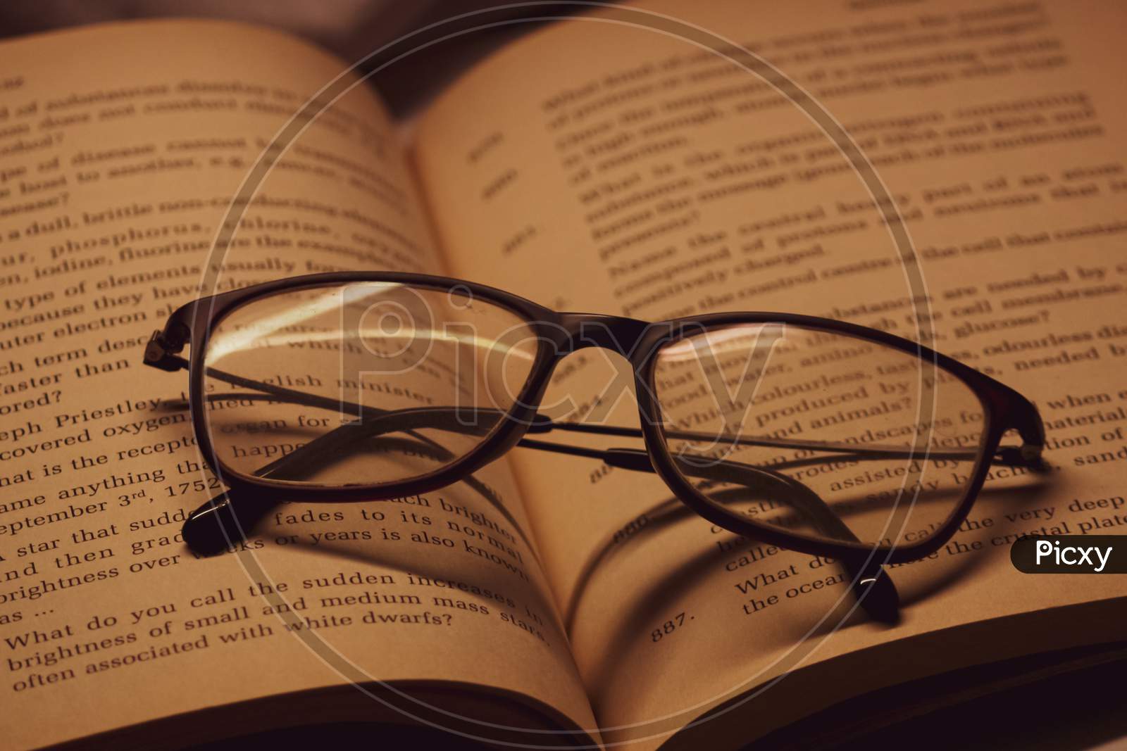 closeup of a book with glasses on it