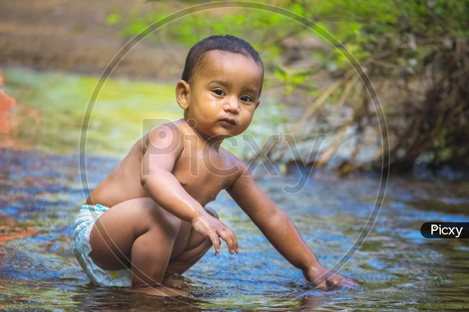 Baby Boy Stock Images -  Little Cute Baby Boy Playing In River Water. Portrait of Boy Child Having Fun and Joy On a Forest River. Little Funny Boy Playing In Water.