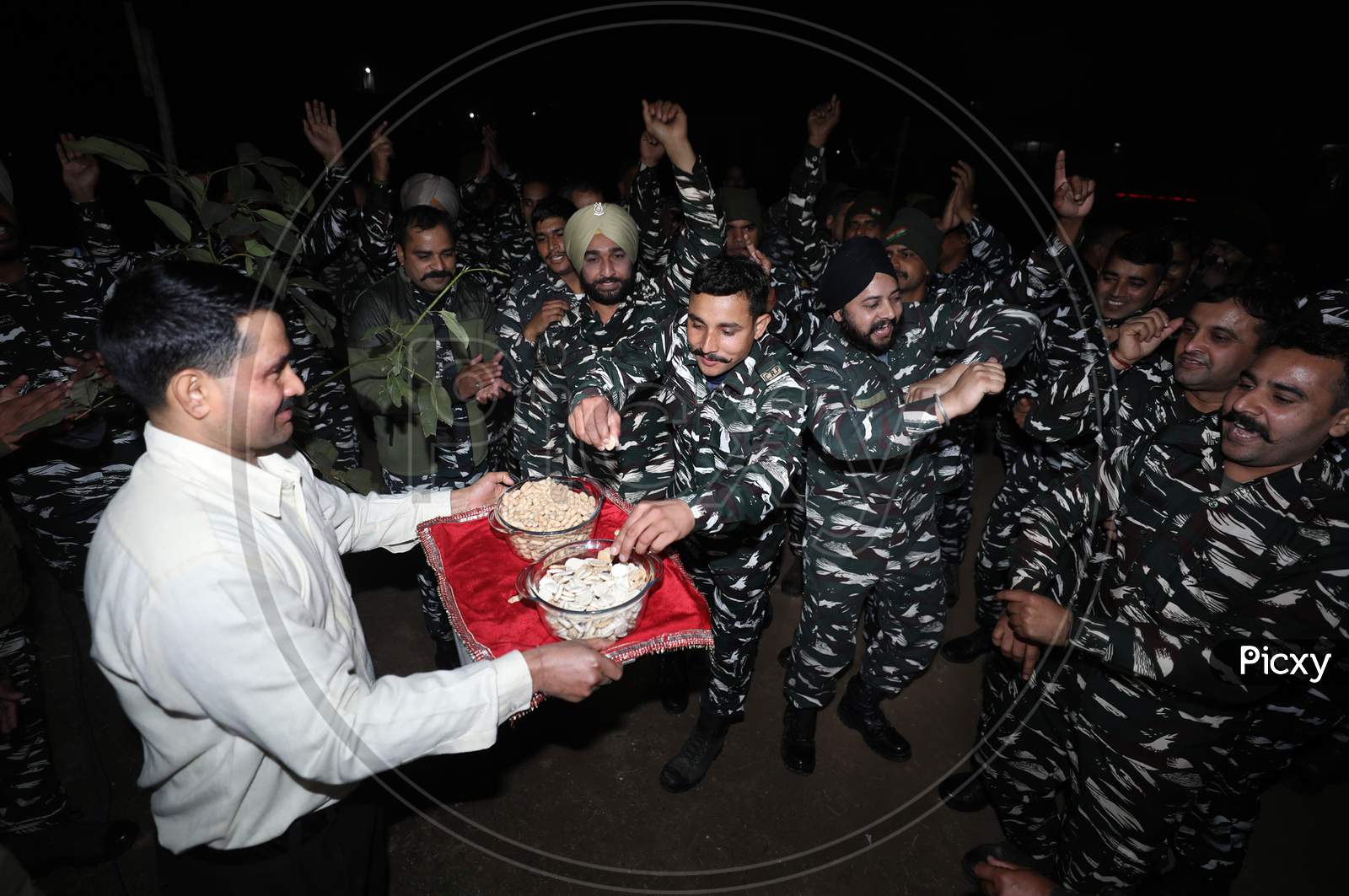 CRPF personnel dance as they celebrate the Lohri festival at camp in Jammu,13 Jan,2021,