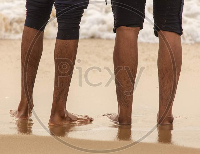 Friends Enjoying The Waves In The Beach, Marina Beach, Chennai. Focus Set On Foot