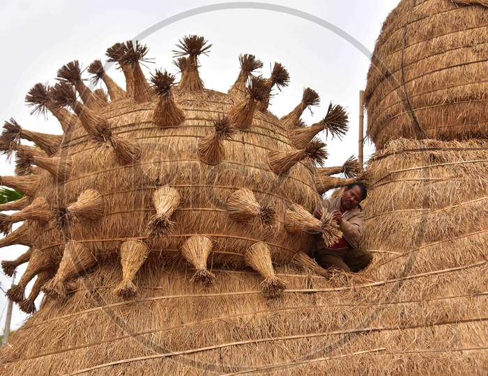 Workers prepare a makeshift cottage called Bhelaghar with protecting the world from COVID-19 as a theme ahead of the Magh Bihu festival in Nagaon district, in the northeastern state of Assam on Jan 13,2021