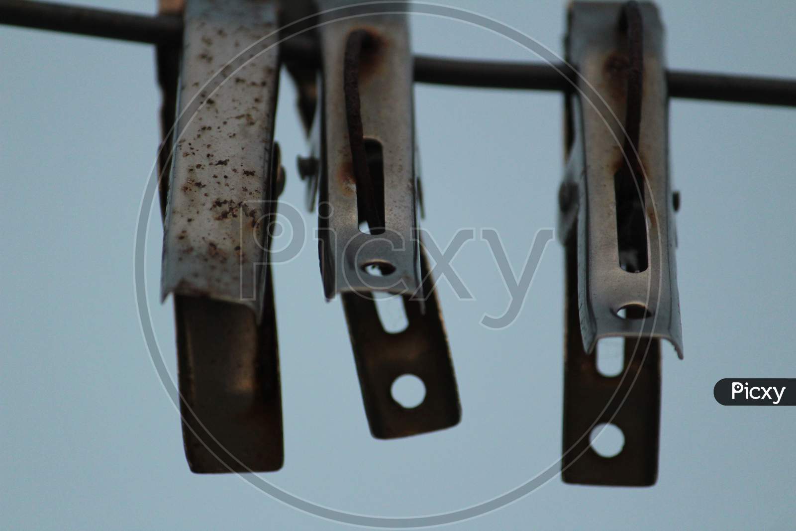 Image of Group Of Color And Stainless Steel Clips Hang On The Rope Without  Clothes-DT256842-Picxy