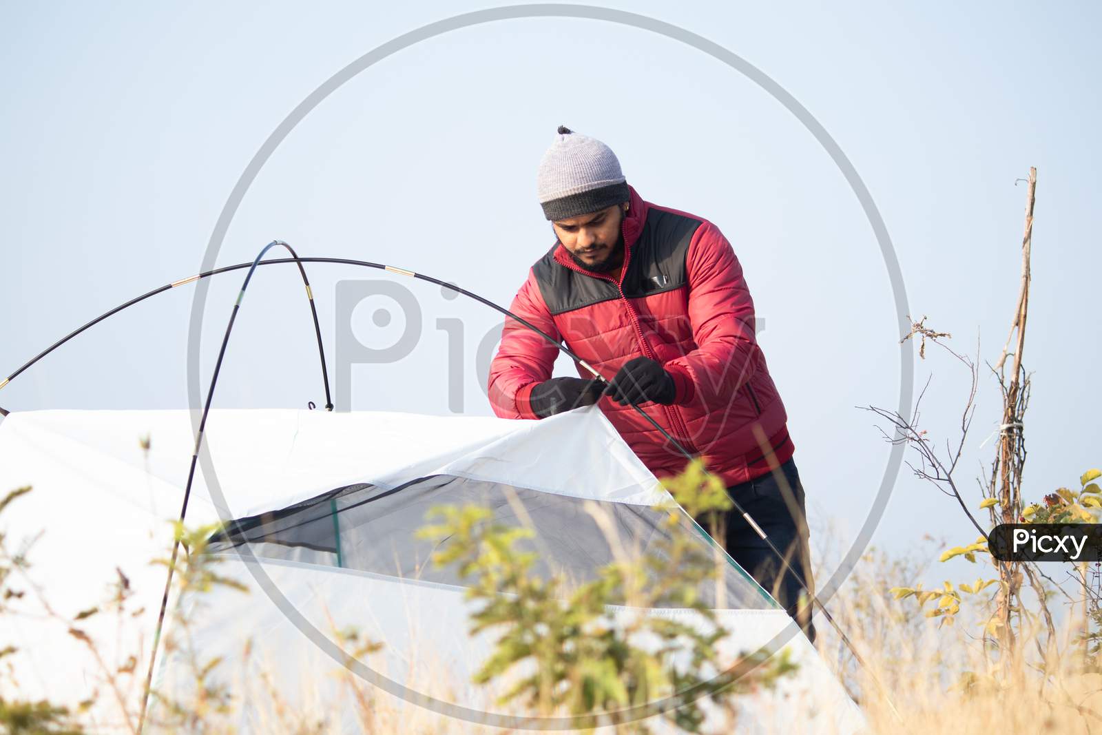 Hiker Busy Setting Up Camping Tent On Top Of Hill - Tourism, Travel, Hiking,Camping And Trekking Concept.