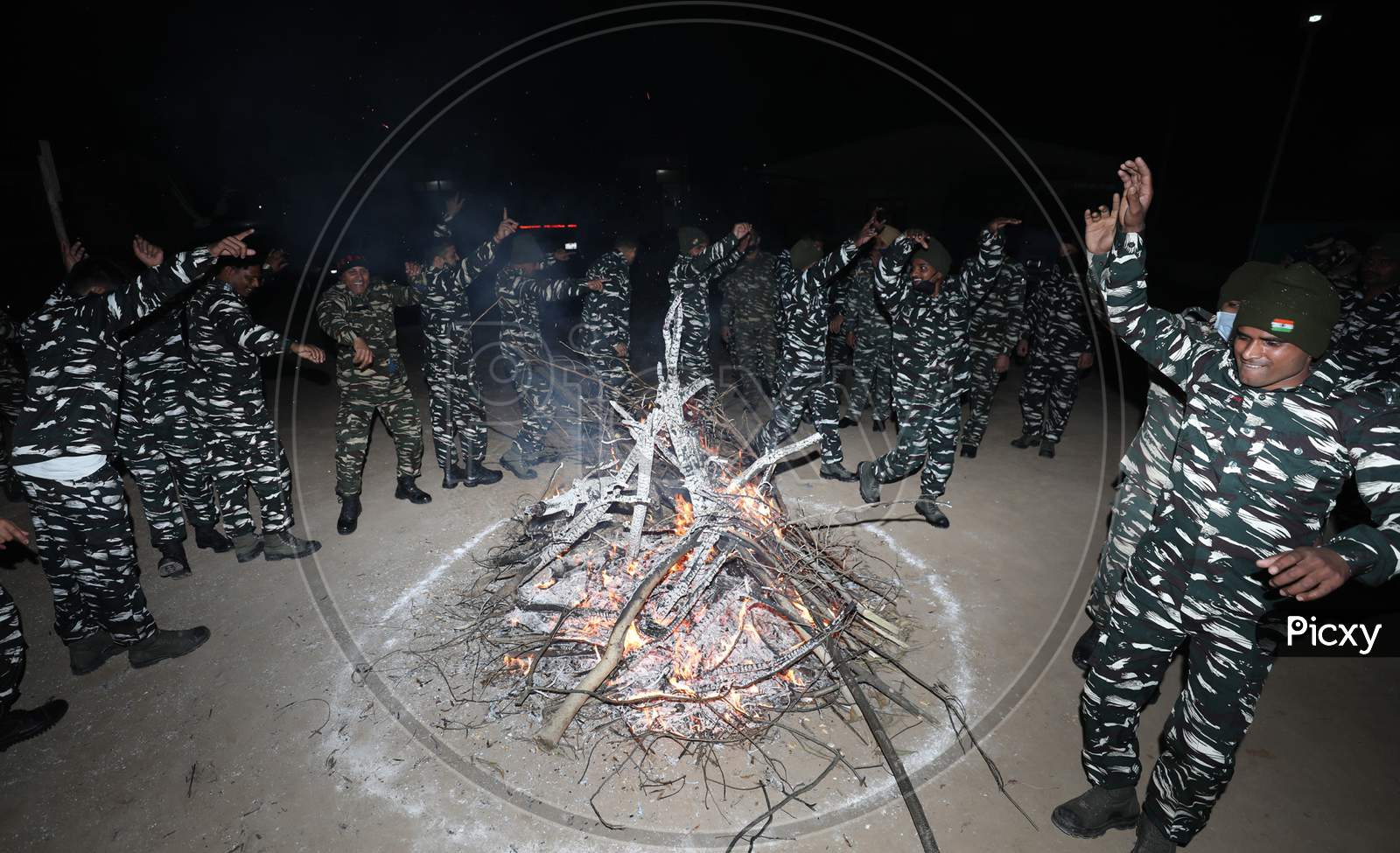 CRPF personnel dance as they celebrate the Lohri festival at camp in Jammu,13 Jan,2021,