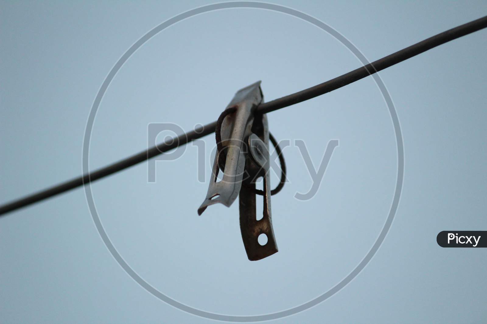 Image of Group Of Color And Stainless Steel Clips Hang On The Rope Without  Clothes-FE085771-Picxy