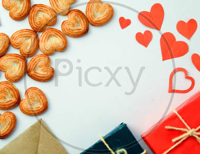 Valentines Day Background With Red Hearts,Ribbon, Message Card,Gift Box And Heart-Shaped Cookies Isolated On White Background