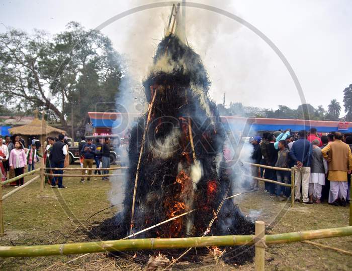 People burning a "Meji" which is made of bamboo and straw during "Bhogali Bihu" celebrations in Nagaon district of Assam on Jan 14,2021.