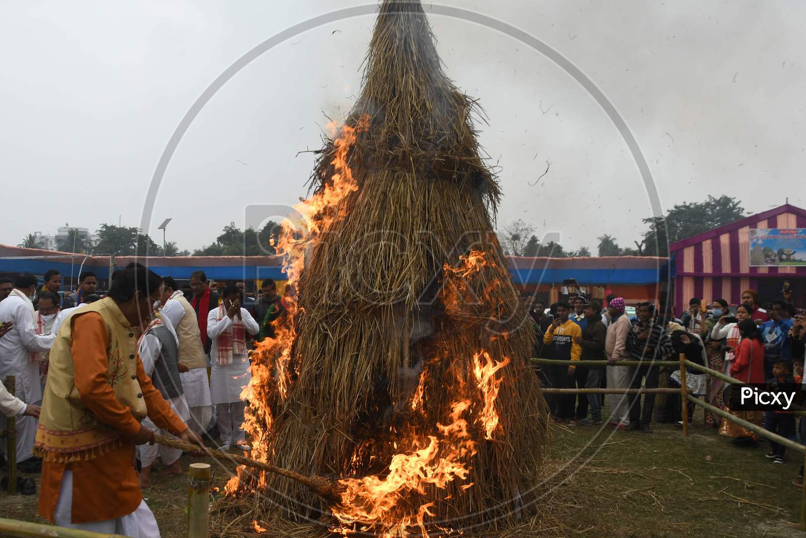 People burning a "Meji" which is made of bamboo and straw during "Bhogali Bihu" celebrations in Nagaon district of Assam on Jan 14,2021.