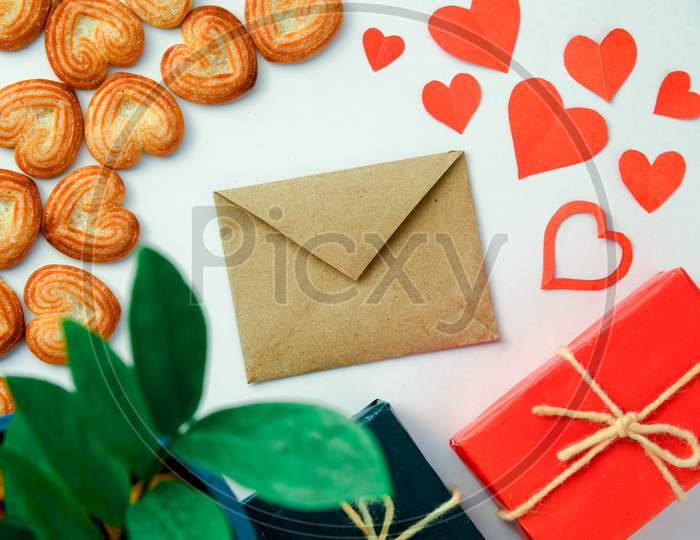 Valentines Day Background With Red Hearts,Ribbon, Message Card,Gift Box And Heart-Shaped Cookies Isolated On White Background