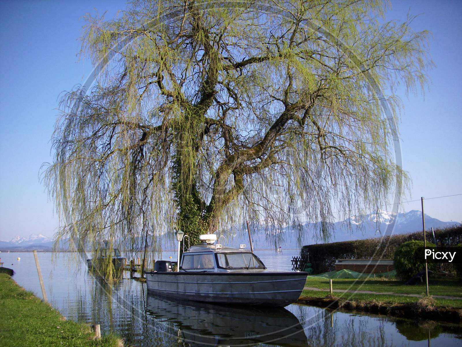 A fisher boat at the island Frauenchiemsee in the Bavarian lake called Chiemsee at a sunny day in summer.