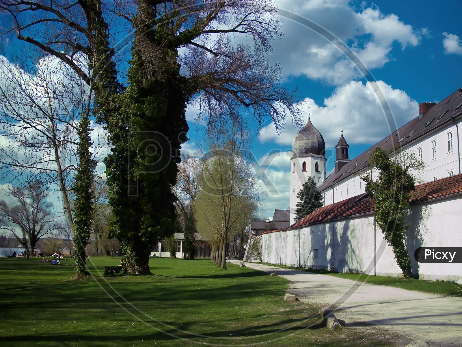The exterior of the monastery called Frauenwörth on the island Frauenchiemsee in the Bavarian lake called Chiemsee at a sunny and cloudy day in summer.