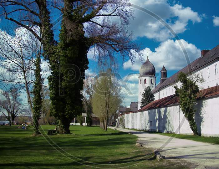 The exterior of the monastery called Frauenwörth on the island Frauenchiemsee in the Bavarian lake called Chiemsee at a sunny and cloudy day in summer.