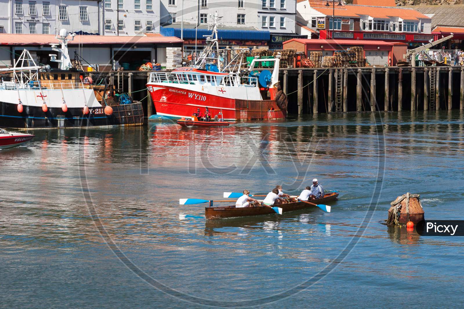 Unidentified Man And Boys Exhausted At The End Of A Rowing Boat Race In Whitby