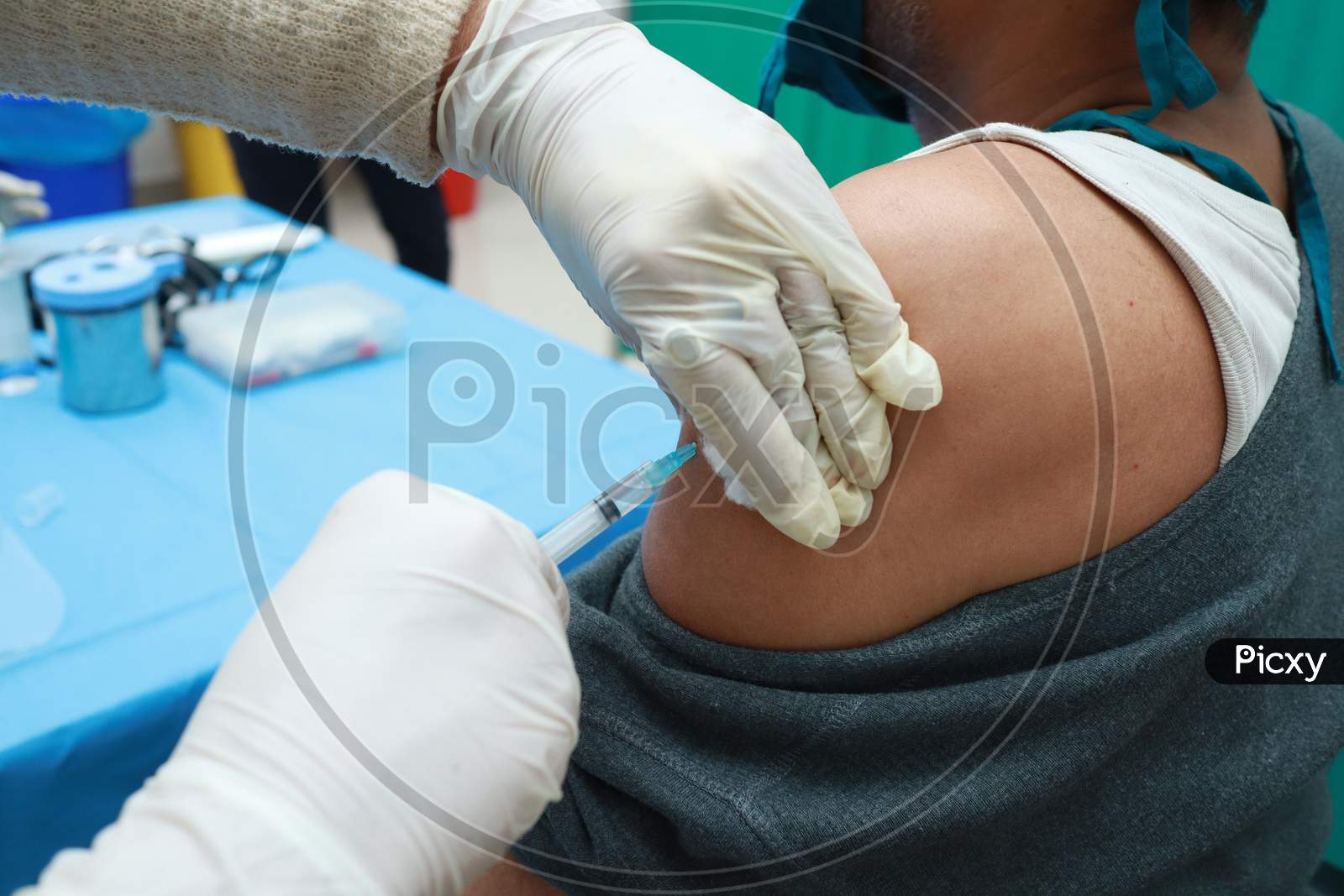 A Close Up Photo Of An Intra Muscular Covid Vaccine Being Given In Arm Of A Patient By A Doctor With Gloved Hand With Selective Focus On Arm