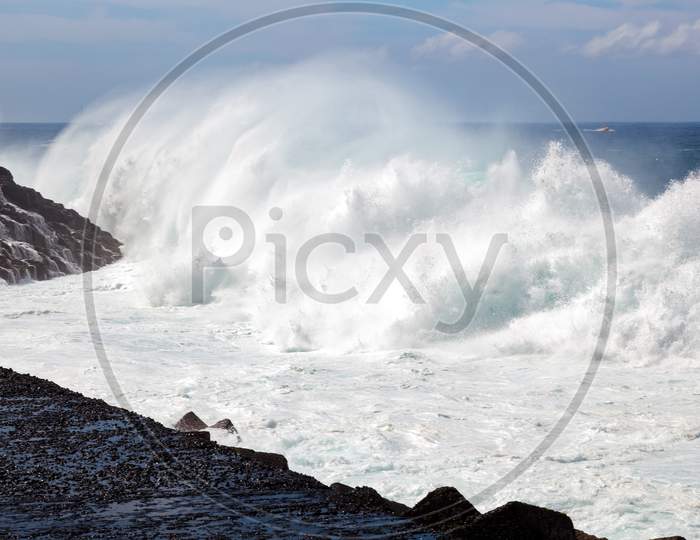 Massive Wave Hitting The Rocky Shore In Tenerife